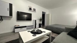 a white living room with a bed and a tv at Park View Studio - NETFLIX in Bucharest