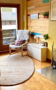 a living room with a chair and a table at Casa Tuca in Candanchú