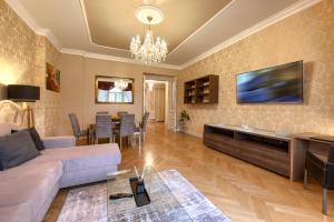 a living room with a couch and a tv at Milosrdnych Apartments in Prague