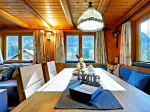 a dining room with a table and a couch at Walserhaus in Brand