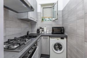 a kitchen with a stove and a washing machine at Casa Venera in Turin +8 photos