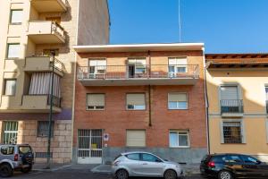 two cars parked in front of a brick building at Casa Venera in Turin