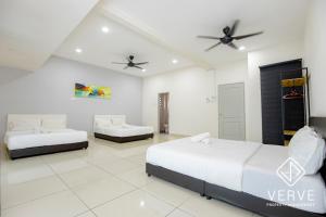 a bedroom with two beds and a ceiling fan at Ipoh Luxury Suites by Verve (18 Pax) EECH16 in Ipoh