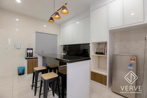 a kitchen with white cabinets and bar stools at Ipoh Luxury Suites by Verve (18 Pax) EECH16 in Ipoh