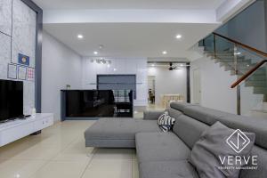 a living room with a couch and a tv at Ipoh Luxury Suites by Verve (18 Pax) EECH16 in Ipoh