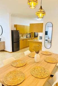 a kitchen with a wooden table with four plates on it at Luxury Modern Home in Summerstrand +39 photos