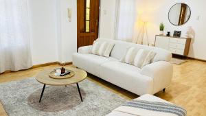 a living room with a white couch and a table at Luxury Modern Home in Summerstrand