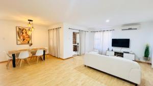 a living room with a white couch and a table at Luxury Modern Home in Summerstrand