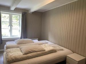 a bed in a room with a window at Brekke Gard Hostel in Flåm