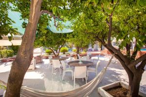 a hammock hanging between two trees on a patio at Villa Amore in Castellammare di Stabia