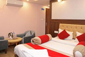 a hotel room with two beds and a table and chairs at Hotel White Rabbit in Kathmandu