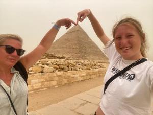 a woman standing in front of a pyramid at LOVELY PYRAMIDS motel in Cairo