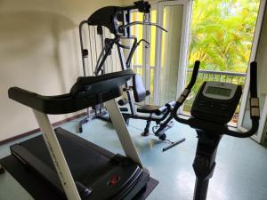 a gym with a treadmill and a phone next to a window at Hotel Casa do Amarelindo in Salvador +37 photos