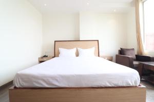 Postel nebo postele na pokoji v ubytování HOTEL JP ROYAL