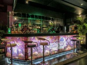 a bar with stools in front of a colorful at Windsor Palace Luxury Heritage Hotel Since 1906 by Paradise Inn Group in Alexandria