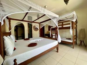 a bedroom with two bunk beds in a room at Mahali Zanzibar in Paje