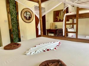 Postel nebo postele na pokoji v ubytování Mahali Zanzibar