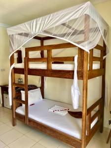 Postel nebo postele na pokoji v ubytování Mahali Zanzibar