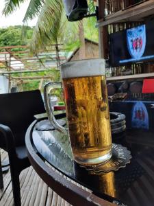 ein Glas Bier auf einem Tisch in der Unterkunft Olivers Binucot Beach House in Romblon