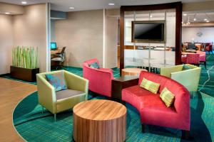 a lobby with chairs and a flat screen tv at SpringHill Suites by Marriott Philadelphia Willow Grove in Willow Grove