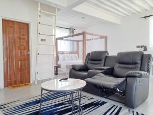 a living room with a couch and a table at Cave Diani Holiday Apartments in Diani Beach