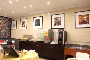 a waiting room with a cash register and pictures on the wall at Club Hotel in Milan