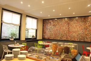 a restaurant with a table with food on it at Club Hotel in Milan