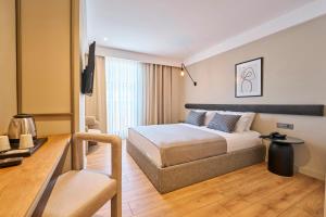 a hotel room with a bed and a desk at La Maja Hotel in Antalya