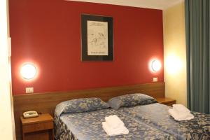 Postel nebo postele na pokoji v ubytování Club Hotel