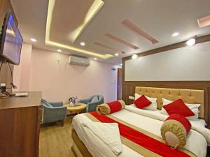 a hotel room with a bed and a flat screen tv at Hotel White Rabbit in Kathmandu