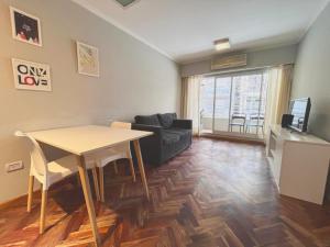 a living room with a table and a couch at Depto San Lorenzo in Rosario