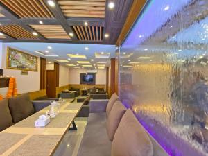 a restaurant with two tables and a glass wall at Hotel White Rabbit in Kathmandu