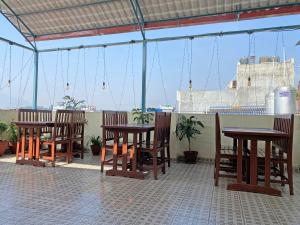 a patio with tables and chairs and a view of a ship at Hotel White Rabbit in Kathmandu