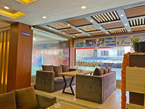 a restaurant with a table and chairs and a window at Hotel White Rabbit in Kathmandu