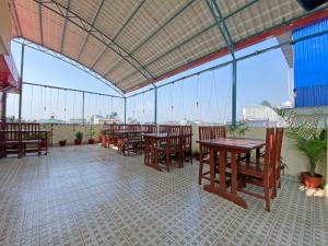 a large room with tables and chairs and windows at Hotel White Rabbit in Kathmandu