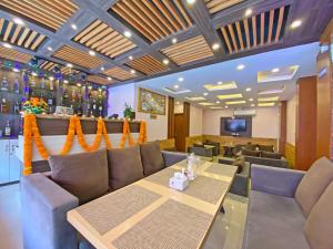a restaurant with couches and a table and a bar at Hotel White Rabbit in Kathmandu
