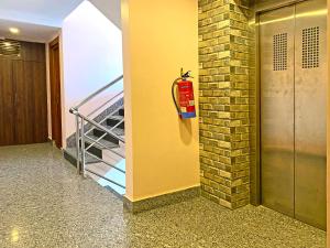 a fire extinguisher on a wall next to a staircase at Hotel White Rabbit in Kathmandu