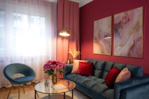 a living room with a blue couch and a table at Designer Luxury Apartment near Prater in Vienna