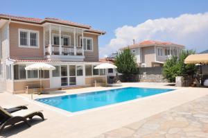 a villa with a swimming pool and a house at Villa Steve in Fethiye