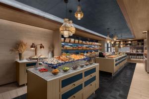 a bakery with many different types of food on display at Courtyard by Marriott Bangkok Sukhumvit 20 in Bangkok