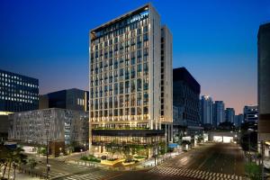 a tall building in a city at night at GRAVITY JOSUN Seoul Pangyo, Autograph Collection in Seongnam