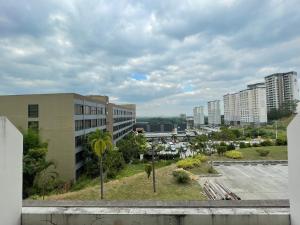 a view of a city with buildings and palm trees at Spacious Luxury Condo w/ kitchen beside Hilton Clark D’Heights in Pampang