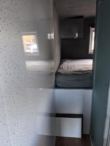 a small room with a bed and a window at Military Shepherd Hut in Haxey