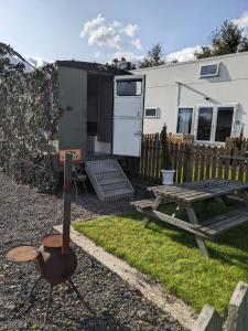a grill and a picnic table in front of a trailer at Military Shepherd Hut in Haxey +15 photos