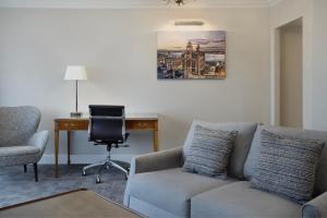 a living room with a couch and a desk and a chair at Delta Hotels by Marriott Liverpool City Centre in Liverpool