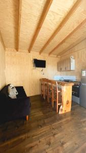 a room with a kitchen and a dining room with a table at Sector 3 de Camping Angostura in Las Cabras