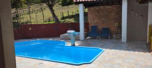 a large blue swimming pool in a yard at Fazenda Riachão in Pojuca