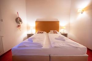 Postel nebo postele na pokoji v ubytování All Seasons Lodge by All in One Apartments