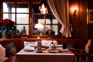 - une table avec de la vaisselle dans une chambre avec une fenêtre dans l'établissement Hotel zum See, Titisee, à Titisee-Neustadt