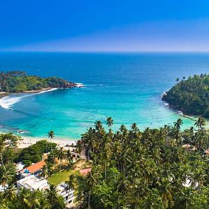 a view of a beach with palm trees and the ocean at Villa 95 in Dickwella